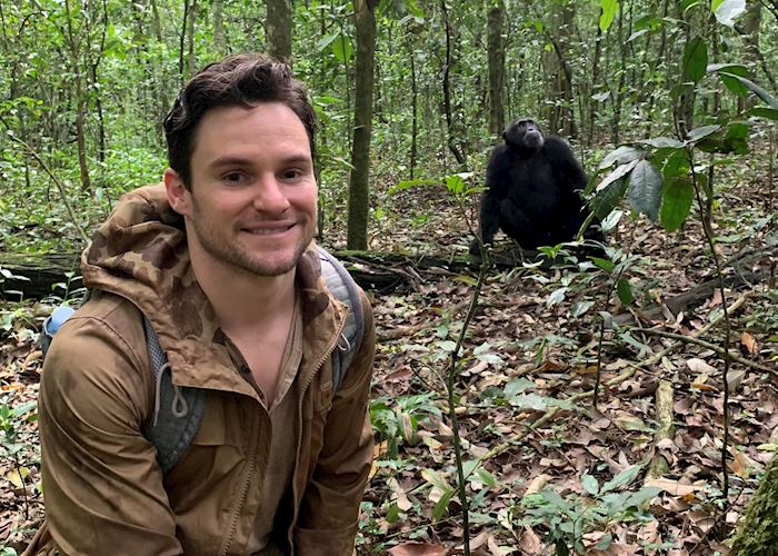 Tom with a chimpanzee in Kibale Forest National Park, Uganda