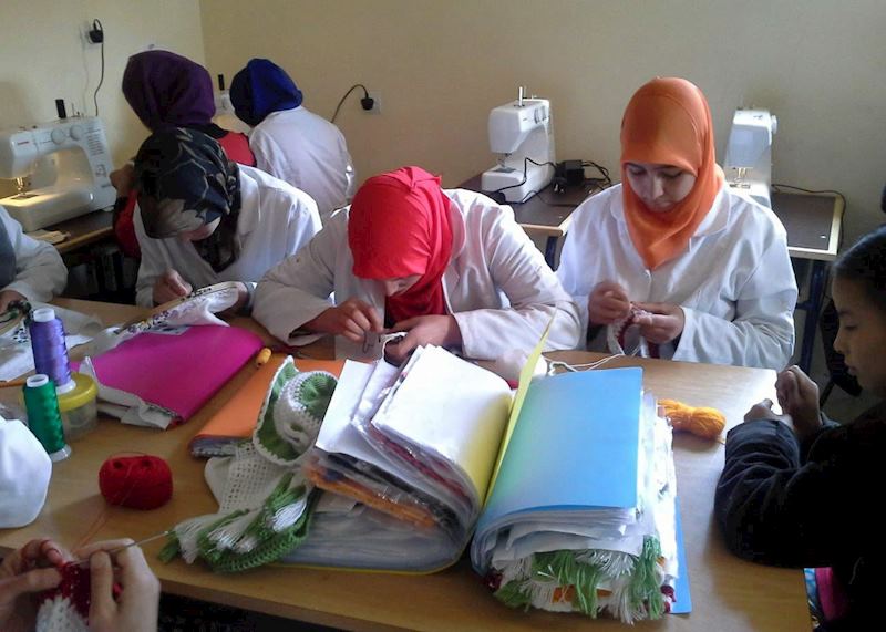 Women learning textile skills in a workshop funded by the Assafou Association
