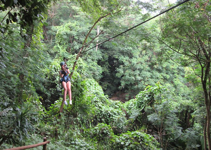 Kate zip-lining through the forest canopy, Seychelles