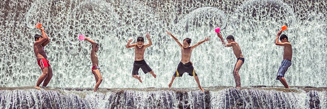 Children playing at the dam in Bali Indonesia by KL KOH
