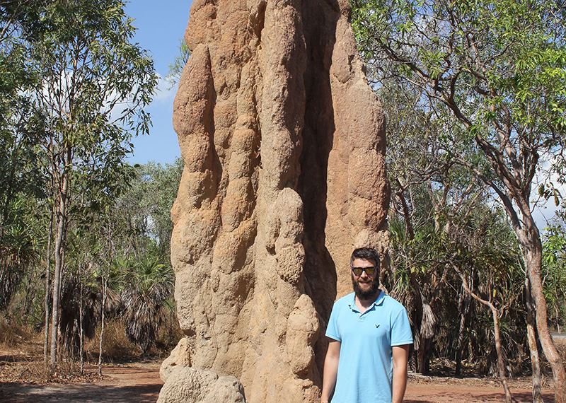 Ross next to a giant termite mound, Northern Territory, Australia