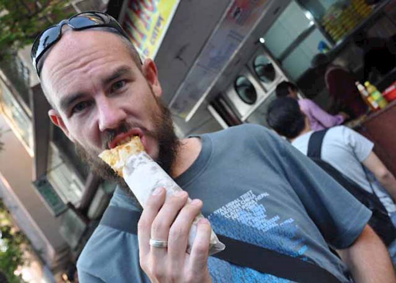 Graham eating a Kati roll