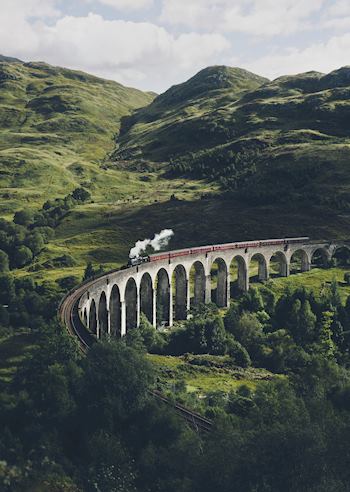 Steam train crossing a viaduct