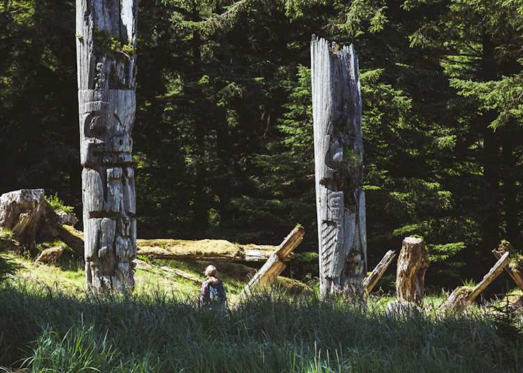 Totem poles at Gwaii Haanas National Park Reserve and Haida Heritage Site — © Destination BC - Brandon Hartwig