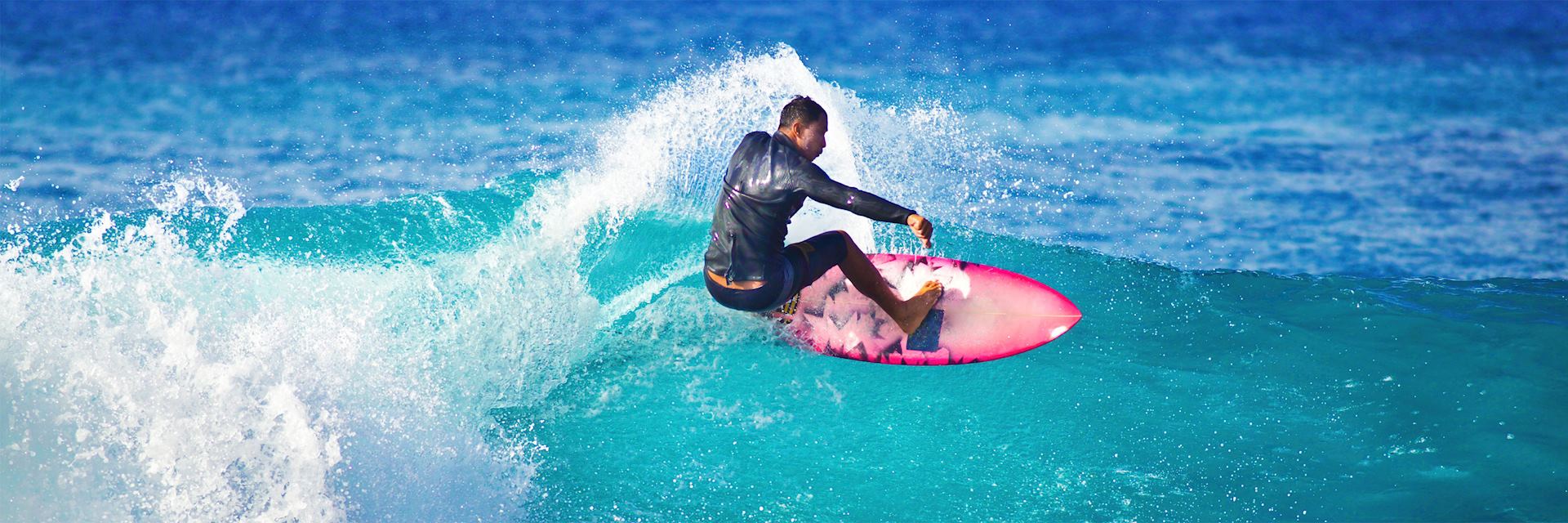 Surfer off the coast of Kauaʻi, Hawaii