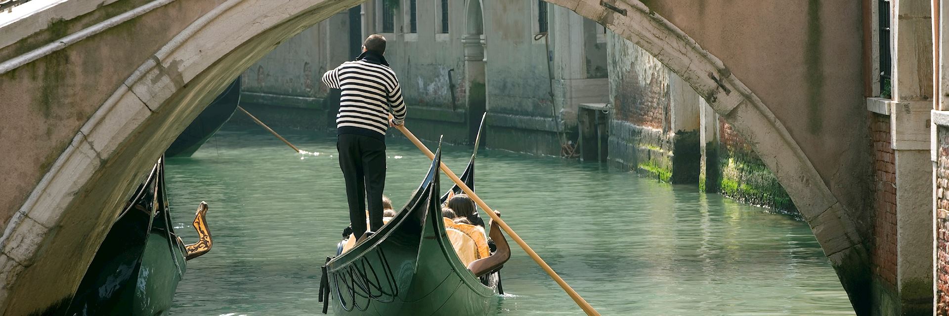 Gondola under an old bridge, Venice