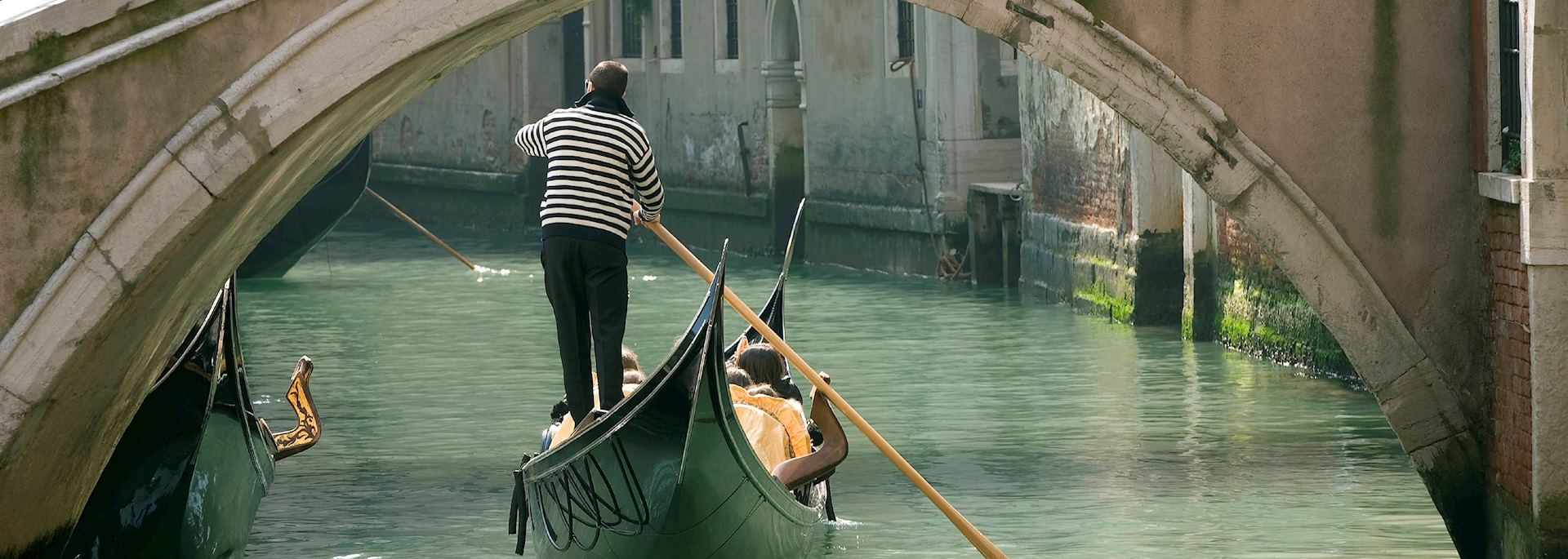 Gondola under an old bridge, Venice
