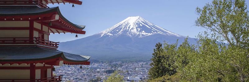 A pagoda overlooks a distant view of Mount Fuji