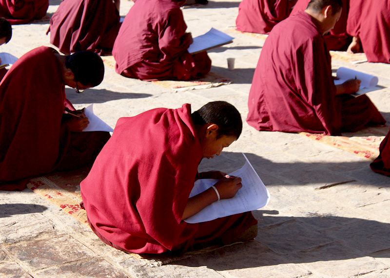 Monks completing an exam paper at Shalu Monastery