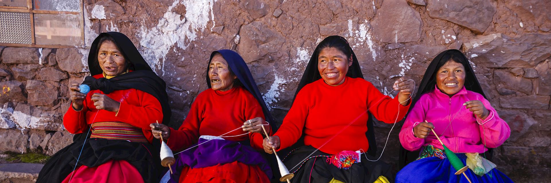 Women spinning wool on Taquile Island, Lake Titicaca, Peru