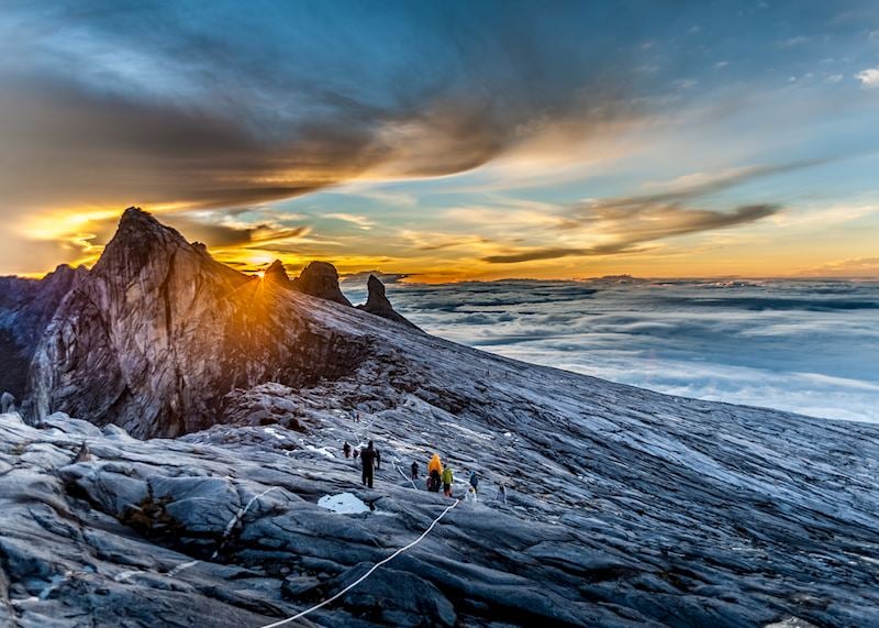 Climbers summiting Mount Kinabalu at sunrise