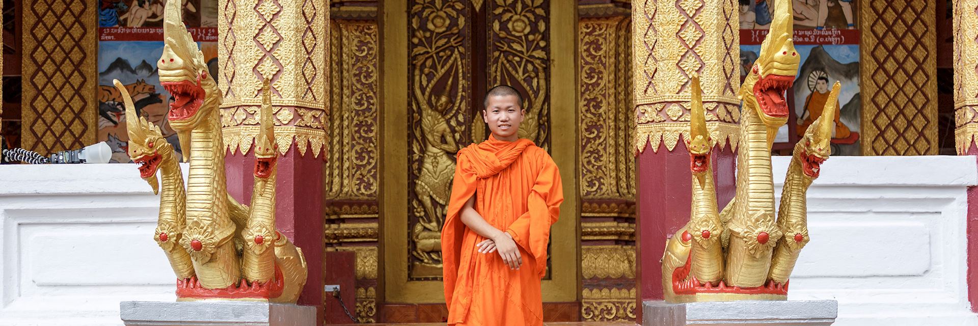 Buddhist monk in font of a monastery, Laos