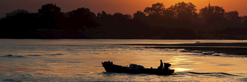 A long-tail boat travelling down the Ayeyarwady River