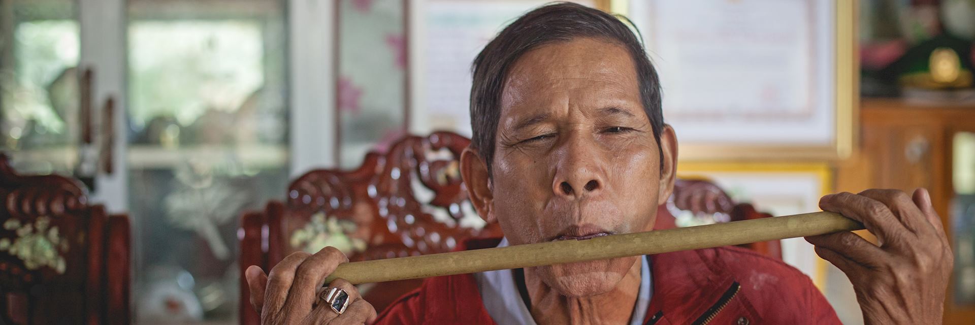 War veteran playing a bamboo instrument in Bho Hoong