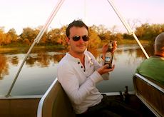 Alex enjoying a beer on the Zambezi River, Botswana