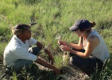 Harriet learning traditional survival techniques from the San Bushman, Central Kalahari, Botswana