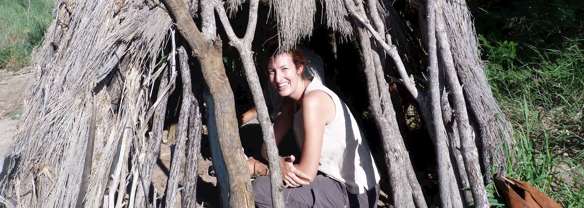 Harriet in a traditional San Bushman shelter, Central Kalahari, Botswana