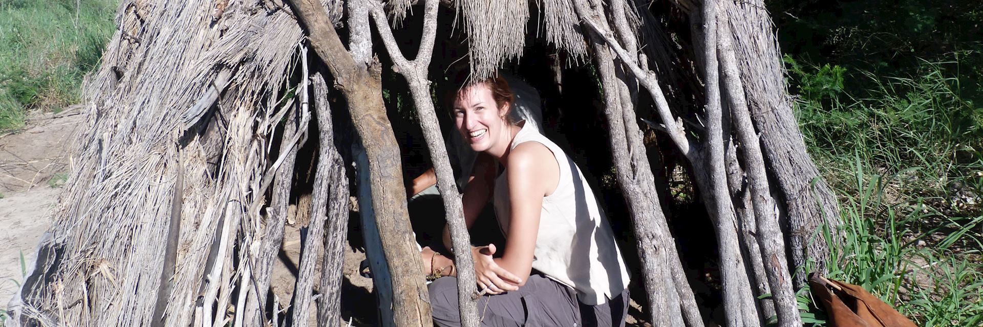 Harriet in a traditional San Bushman shelter, Central Kalahari, Botswana