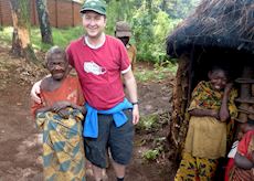 James visiting a pygmy village, Uganda 