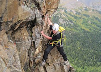 Anna climbing a via ferrata in the Rocky Mountains, Canada