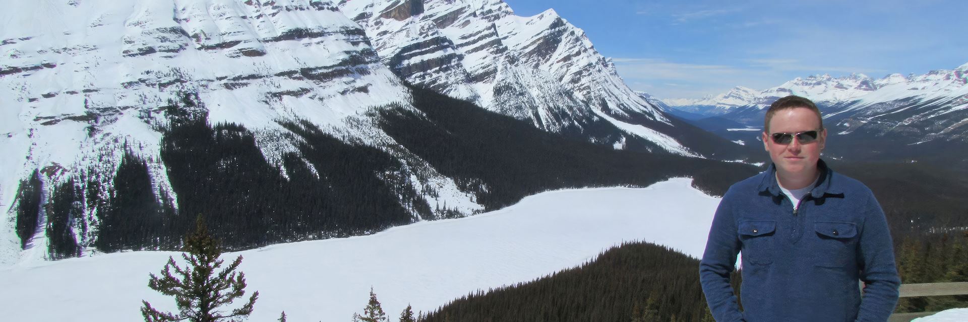 Jon looking out over a frozen Peto Lake, Canada