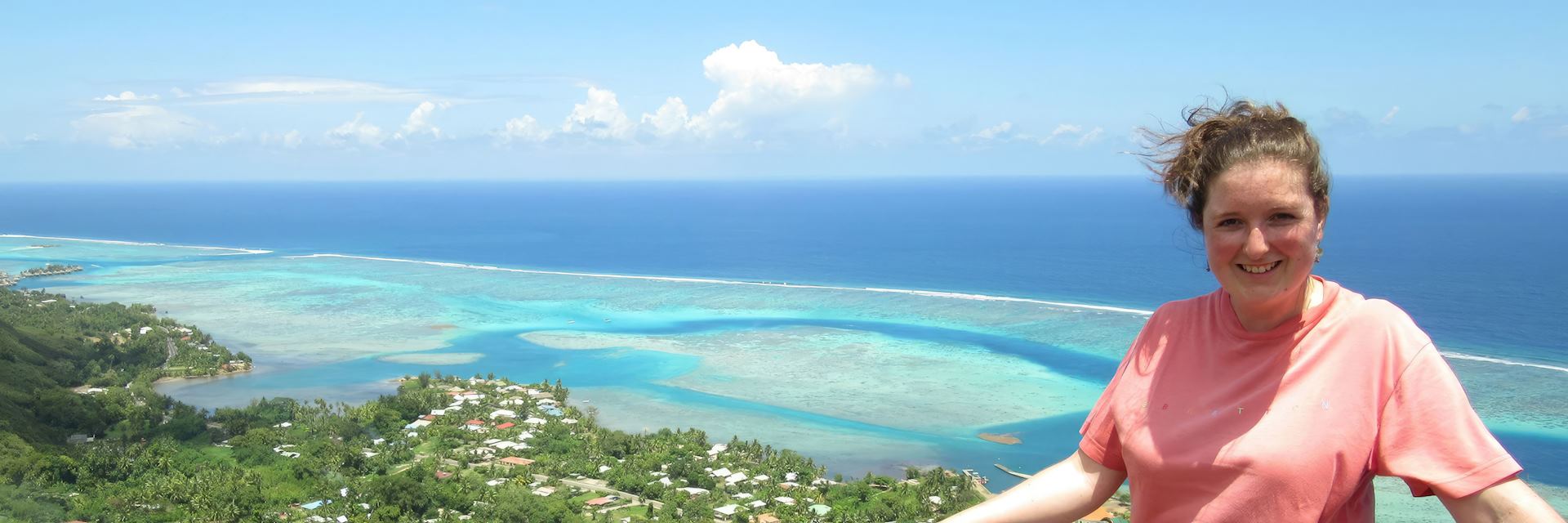 Annabel on top of Magic Mountain looking at the lagoons of Mo'orea, French Polynesia