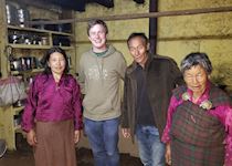 Jackson having dinner with a local family in Phobjikha, Bhutan