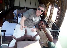 James driving a houseboat in the Keralan Backwaters, India