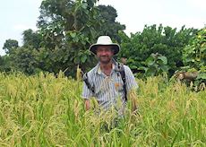 Alex trekking through sticky rice fields in Luang Prabang, Laos