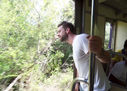 Mat catching some rays on a rural train in Thailand