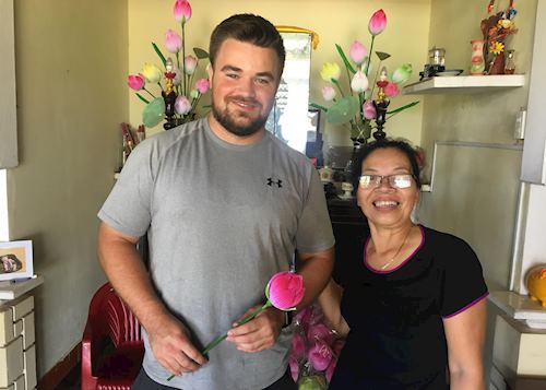 Patrick creating paper flowers with a local in Hoi An, Vietnam