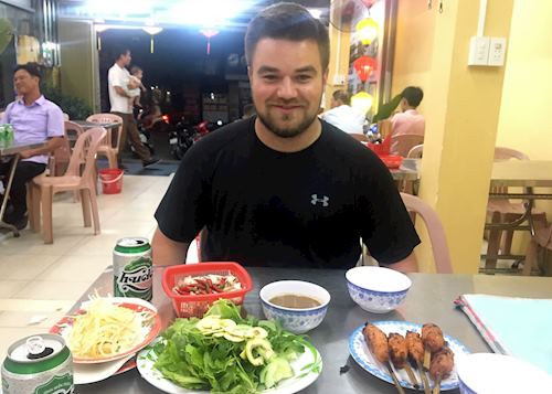 Patrick eating bún thịt nướng in Hue, Vietnam