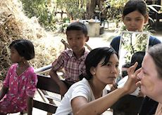 Sophie having traditional Thanaka applied by a local in Salay, Myanmar