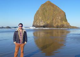 Carl at Cannon Beach with Haystack Rock in the background, USA