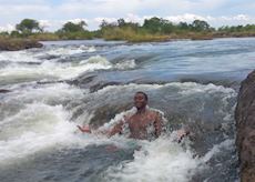 David swimming on the edge of Victoria Falls