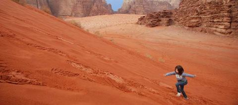 Climbing a dune in Wadi Rum Climbing a dune in Wadi Rum