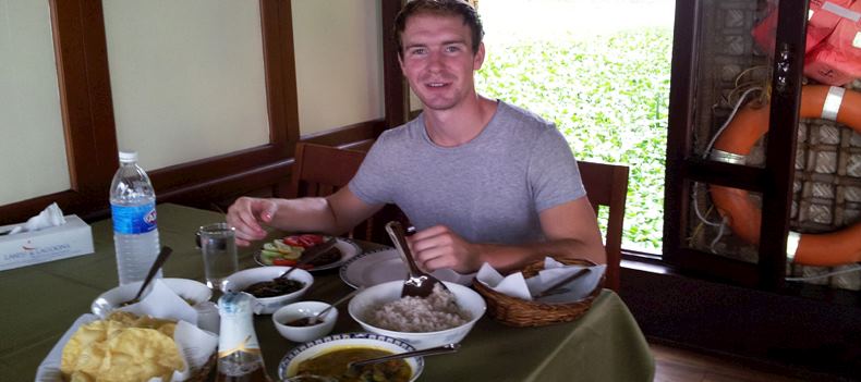 Niall enjoying a curry dish on a Keralan rice boat