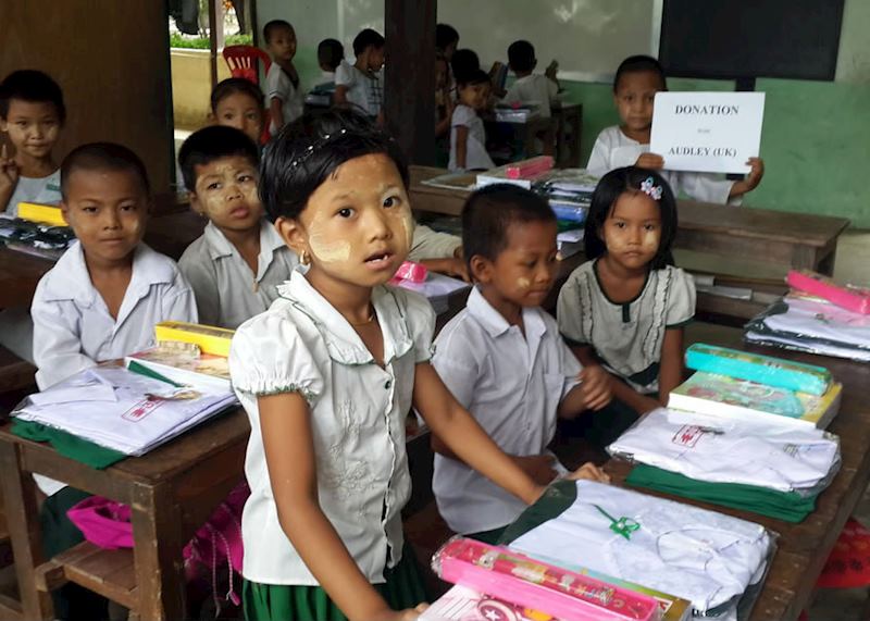 Children show off their new school uniforms